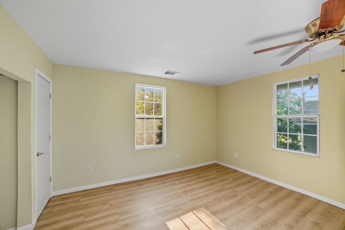 1413 South 2nd Street Temple, TX 76504 - Photo 18 of 24 Unfurnished room with light wood-style flooring and a ceiling fan
