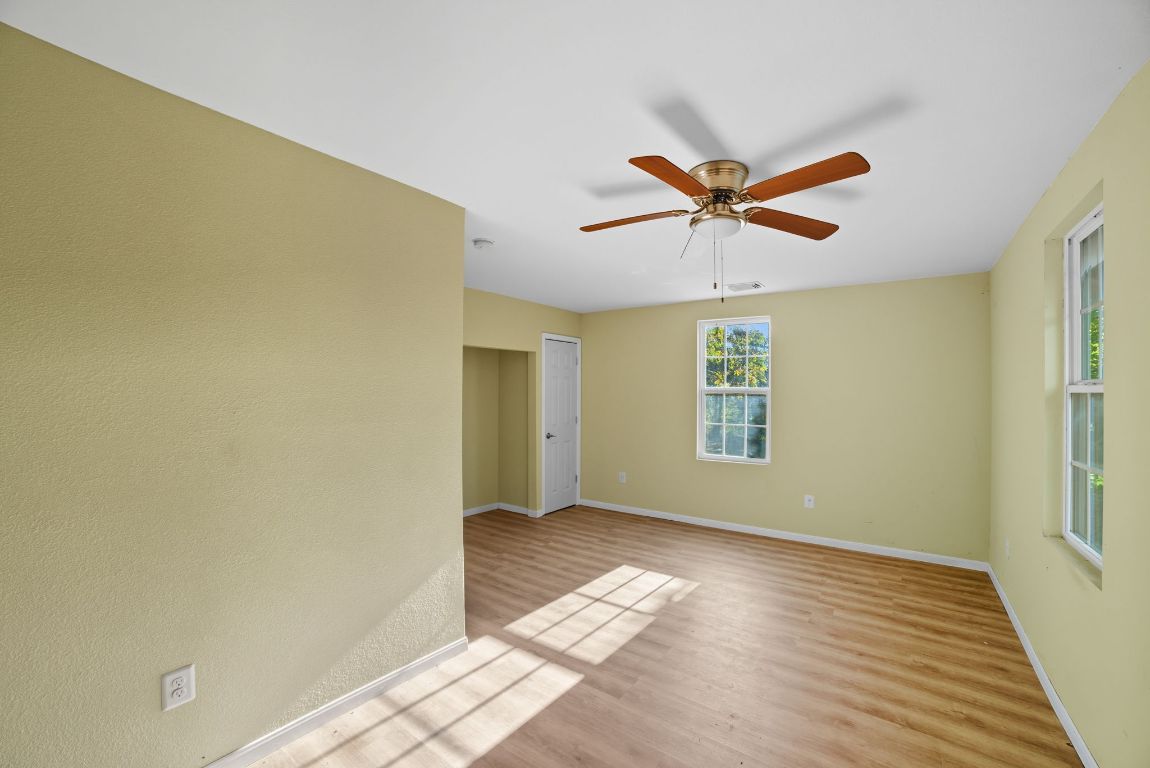 1413 South 2nd Street Temple, TX 76504 - Photo 19 of 24 Empty room with light wood-style flooring and ceiling fan
