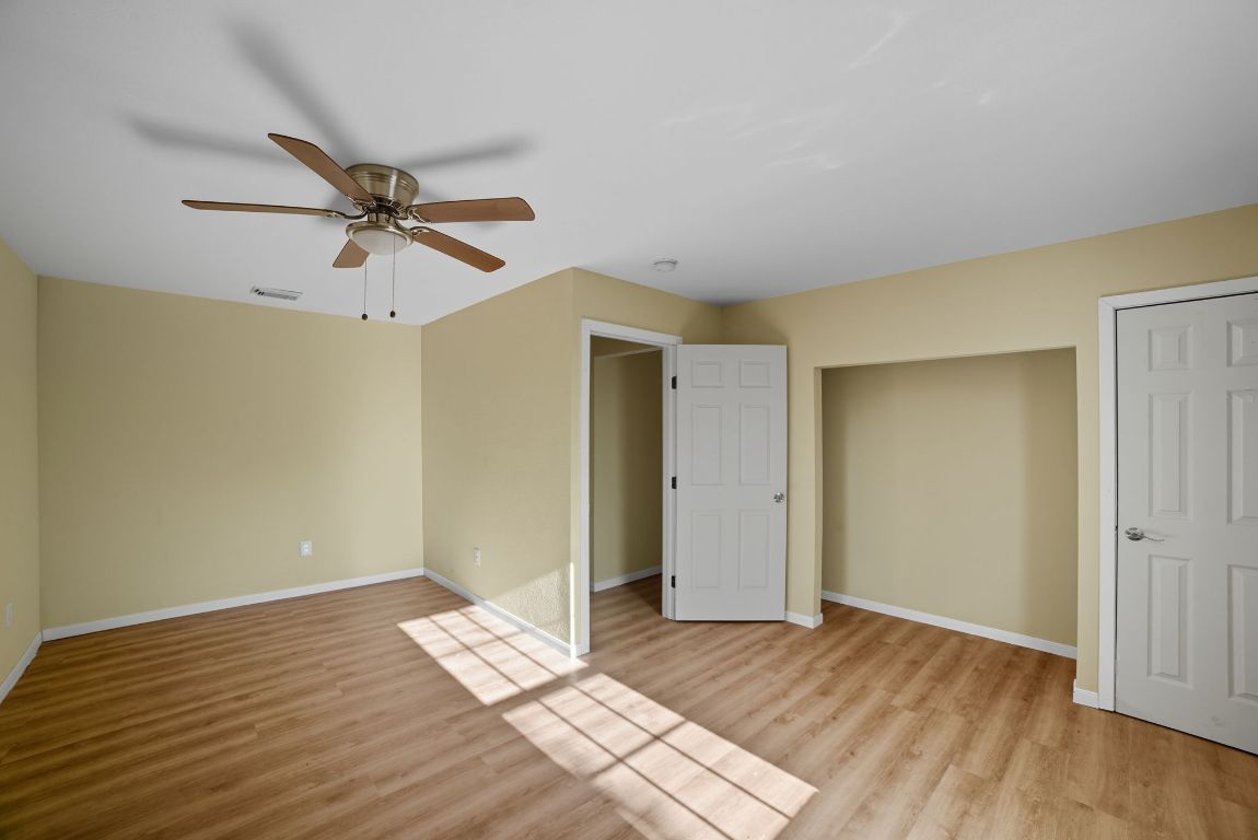 1413 South 2nd Street Temple, TX 76504 - Photo 6 of 24 Unfurnished bedroom featuring light wood-style floors and a ceiling fan