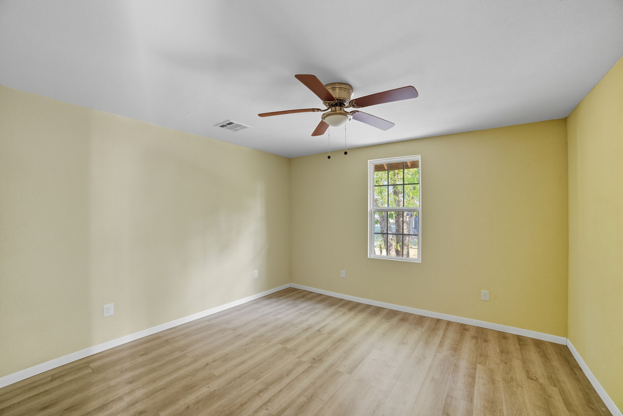 1413 South 2nd Street Temple, TX 76504 - Photo 7 of 24 a view of an empty room with window and wooden floor