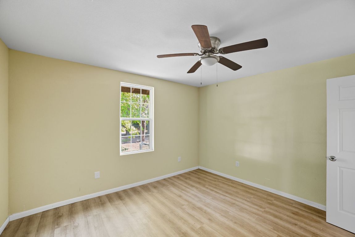1413 South 2nd Street Temple, TX 76504 - Photo 8 of 24 Unfurnished room featuring light wood-style flooring and a ceiling fan
