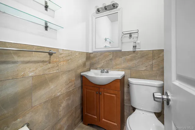 a bathroom with a sink a toilet and mirror