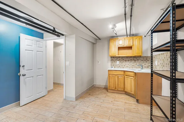 a bathroom with a granite countertop sink a mirror and a shower