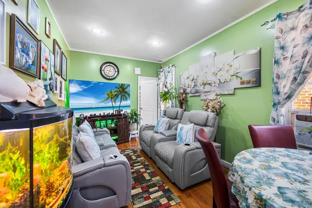 a living room with furniture and painting on the wall