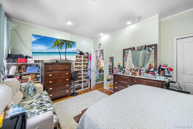 a bedroom with furniture and a flat screen tv
