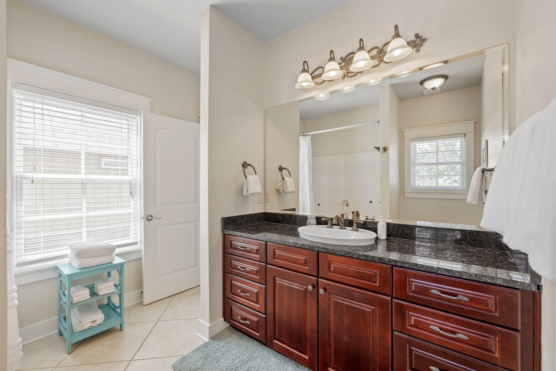 39 Willow Mist Road Inlet Beach, FL 32461 - Photo 18 of 41 a bathroom with a granite countertop sink a large mirror and a window