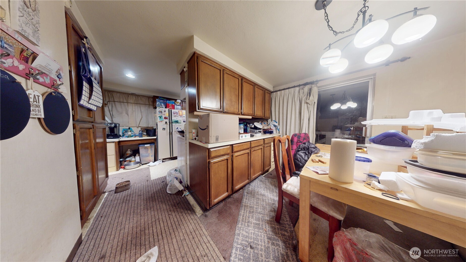 16835 113th Avenue Southeast Renton, WA 98055 - Photo 22 of 34 a kitchen filled with stainless steel appliances kitchen island granite countertop a refrigerator a sink dishwasher a dining table and chairs with wooden floor