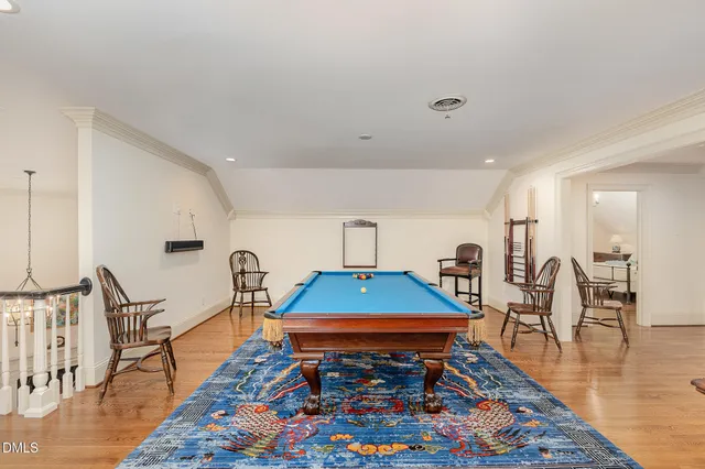 a room with lots of chairs and wooden floor