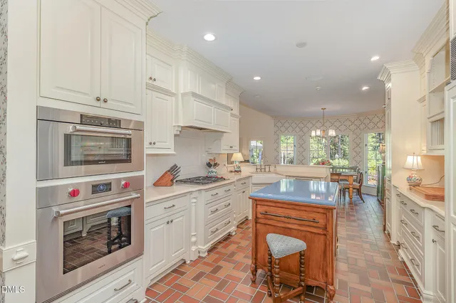 a kitchen with granite countertop a stove top oven sink and cabinets