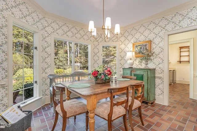 a view of a dining room with furniture a chandelier and wooden floor