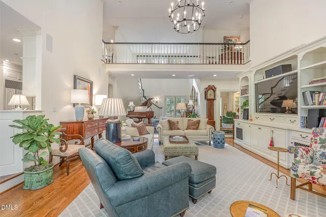 a living room with furniture chandelier and a table