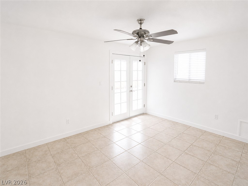 2870 South Sandhill Road Las Vegas, NV 89121 - Photo 30 of 64 Natural light pours into this room, illuminating the pristine tile flooring and French doors.