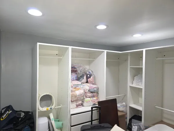 a view of a hallway with workspace and a window