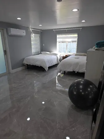 a bedroom with a bed and a chair