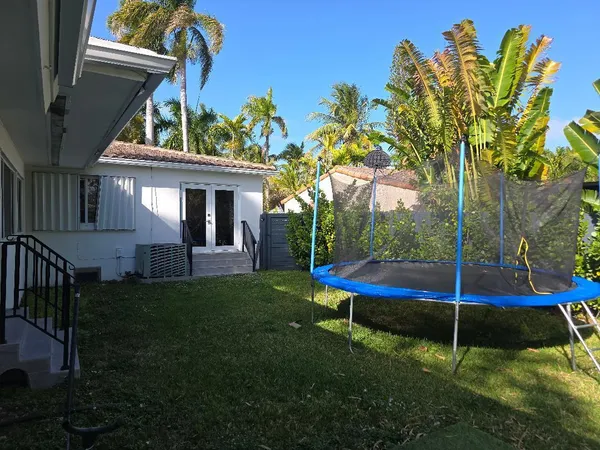 a backyard of a house with table and chairs
