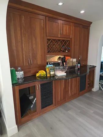 a kitchen with granite countertop wooden cabinets and a sink