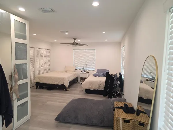 a bedroom with furniture and a large window