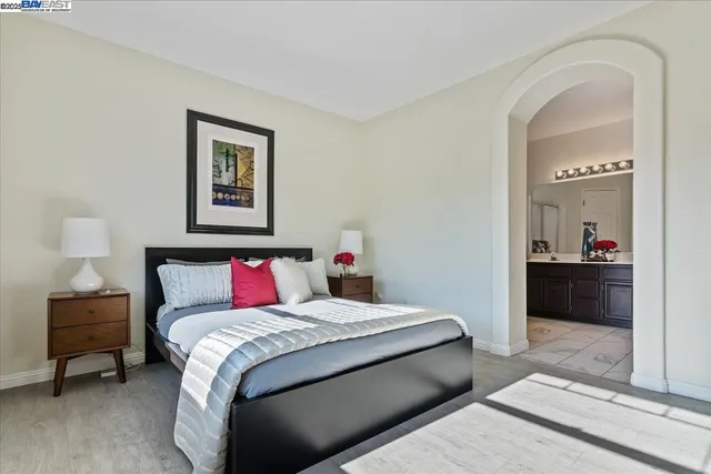 a bedroom with a bed and a view of bathroom