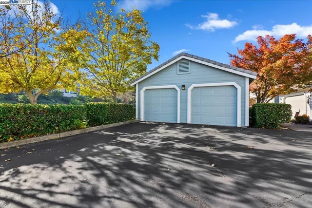 a view of a house with a yard and garage