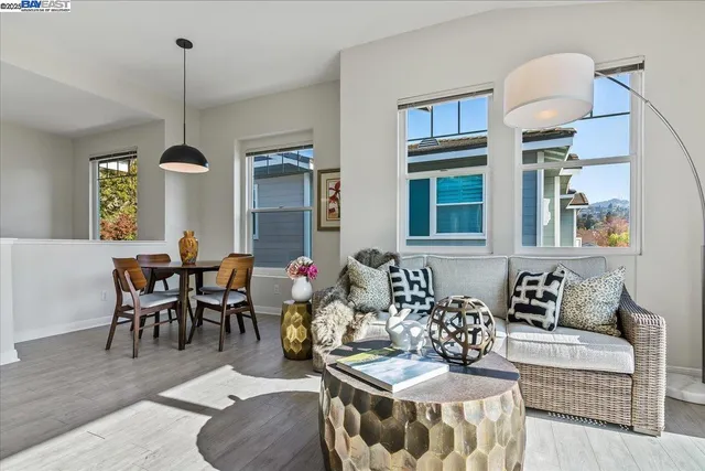 a living room with furniture and a chandelier