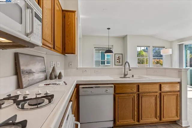 a kitchen with a sink stove and cabinets