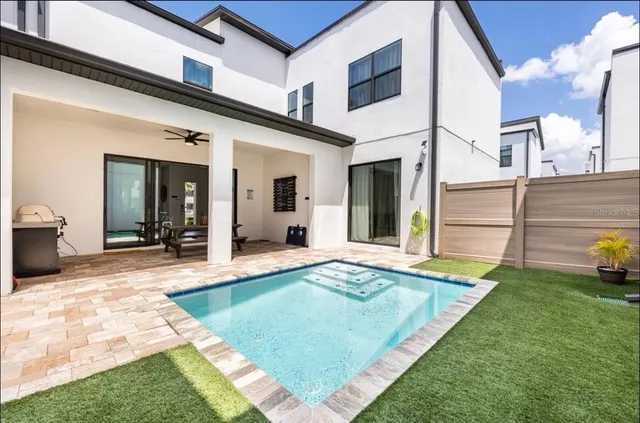 a view of a house with swimming pool and porch