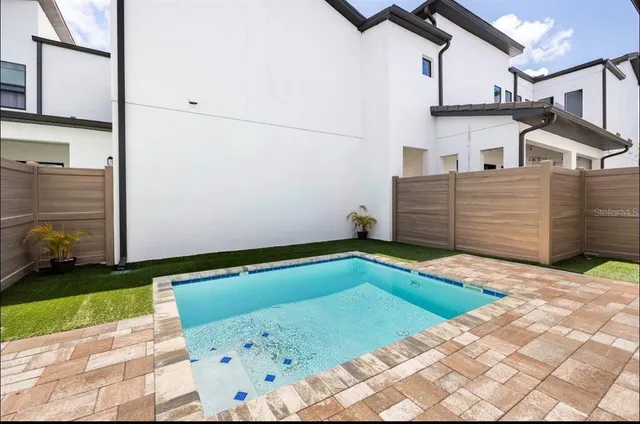 a view of a backyard with sitting area