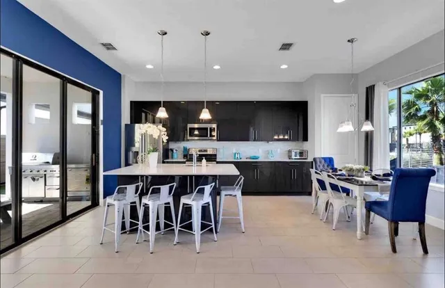 a large kitchen with a table and chairs