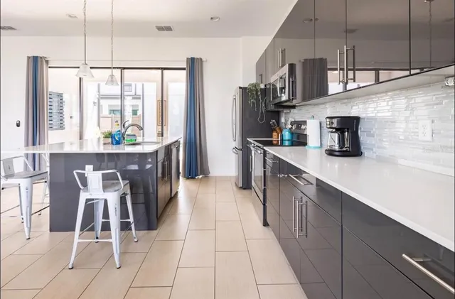 a kitchen with stainless steel appliances kitchen island granite countertop a sink and cabinets