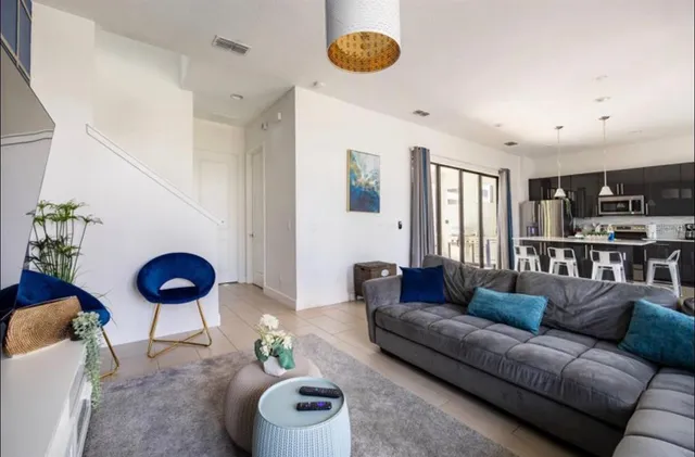 a living room with furniture and a potted plant