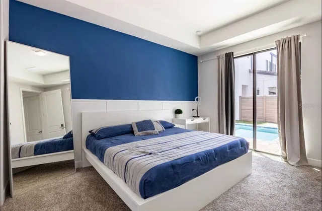 a bedroom with a large bed and a large window