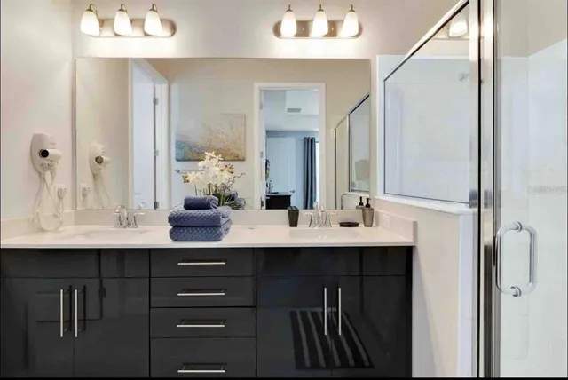 a bathroom with a sink double vanity and a mirror