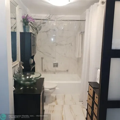 a bathroom with a bathtub and a sink