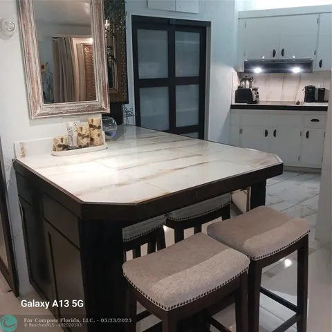 a kitchen with a table and chairs in it