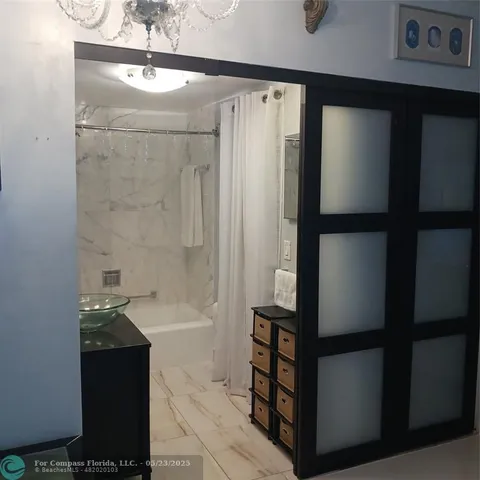 a bathroom with a bathtub and a shower
