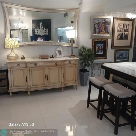 a living room with furniture a fireplace and potted plants