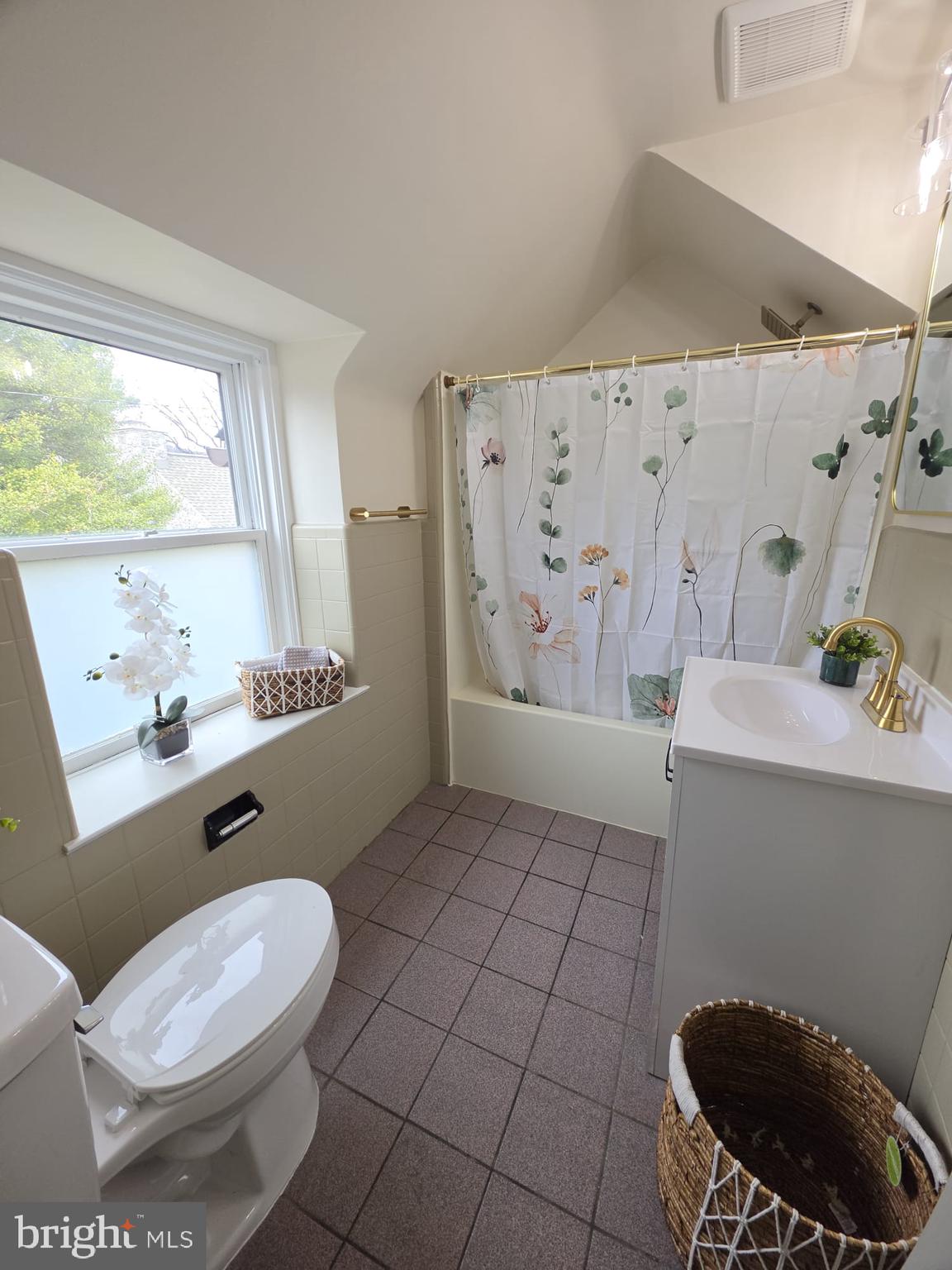 103 North 27th Street Reading, PA 19606 - Photo 11 of 15 a bathroom with a toilet a sink a window and mirror