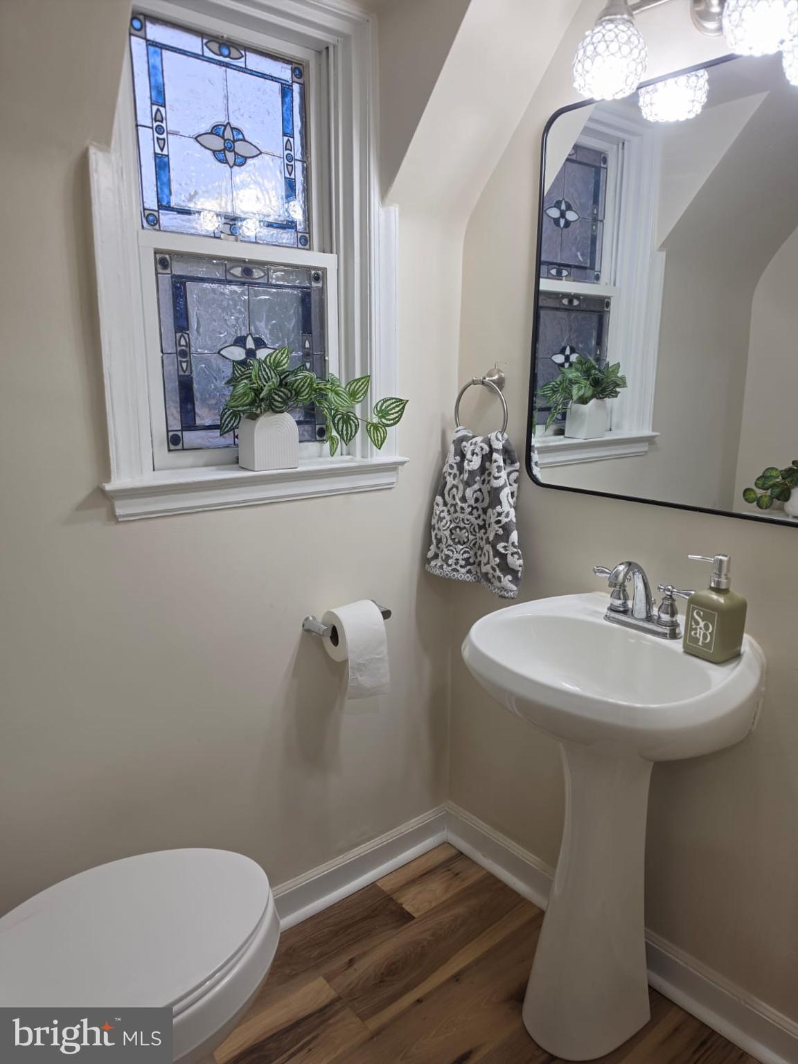 103 North 27th Street Reading, PA 19606 - Photo 12 of 15 a bathroom with a toilet sink and mirror