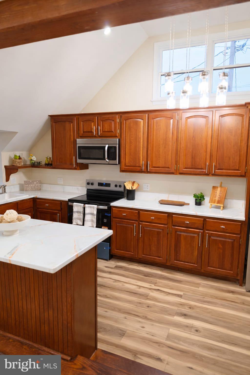 103 North 27th Street Reading, PA 19606 - Photo 5 of 15 a kitchen with stainless steel appliances granite countertop a stove a sink and a microwave