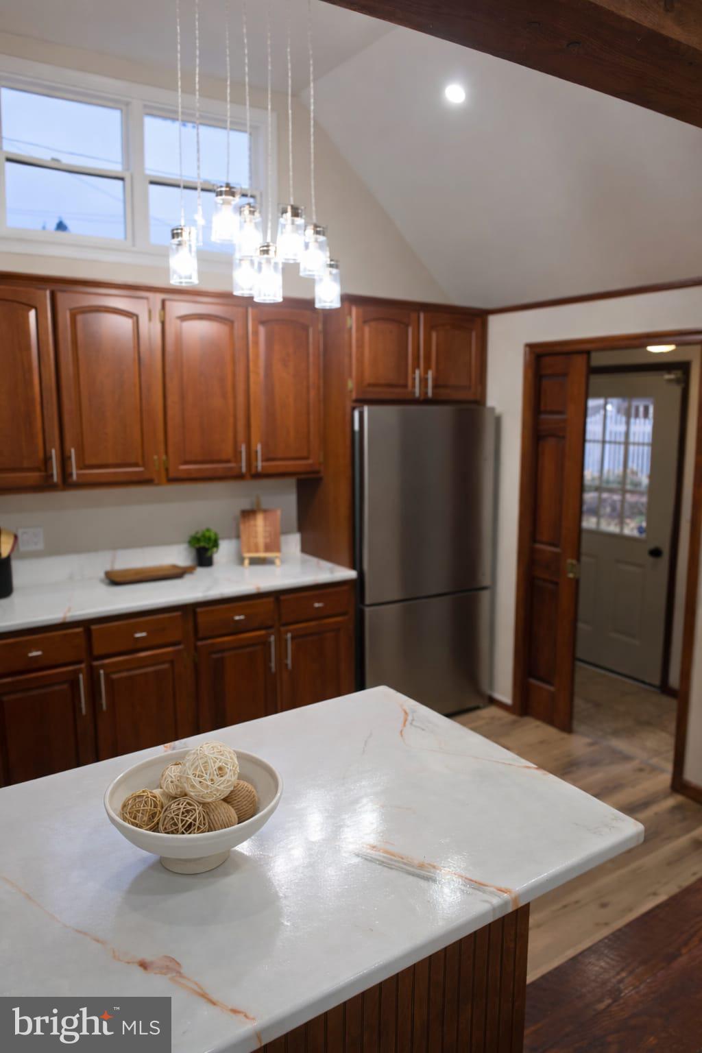 103 North 27th Street Reading, PA 19606 - Photo 6 of 15 a kitchen with stainless steel appliances kitchen island granite countertop a refrigerator a sink dishwasher with a dining table and chairs