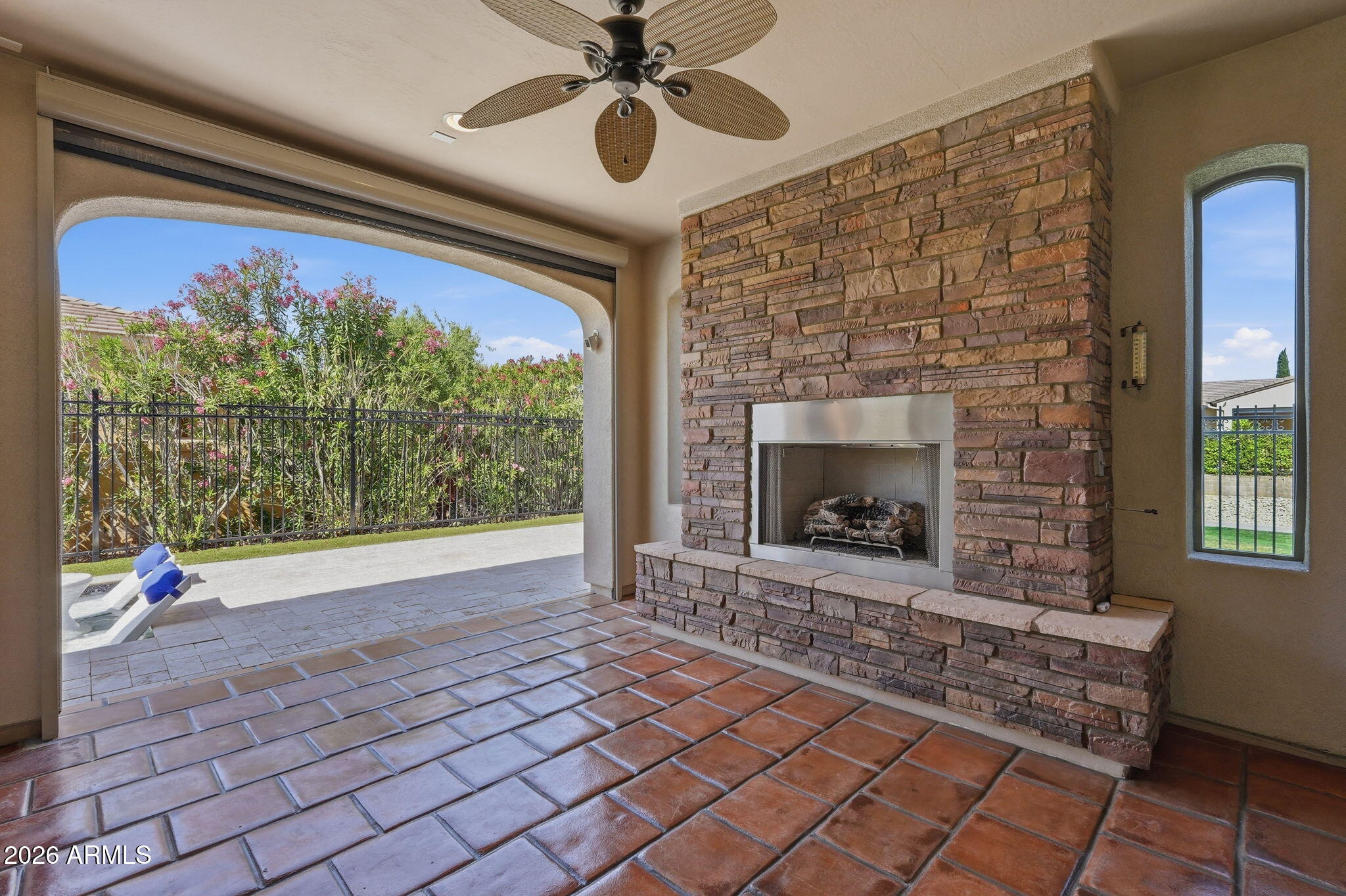 1694 East Grand Ridge Road Queen Creek, AZ 85140 - Photo 35 of 61 a view of an empty room with a fireplace and a chandelier