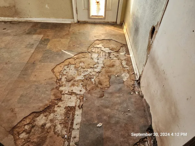 a view of a hallway with stairs and furniture