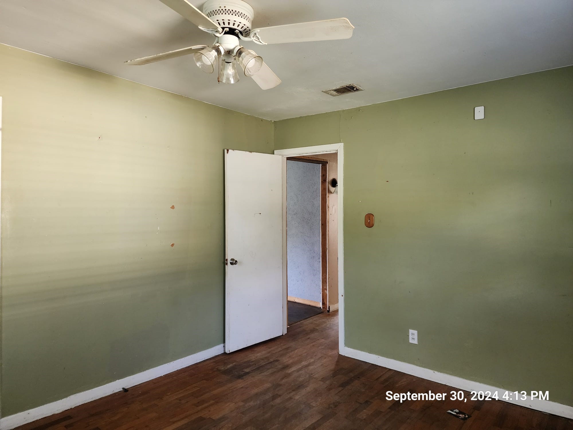 11645 Loop Road Beaumont, TX 77713 - Photo 4 of 20 an empty room with wooden floor and fan