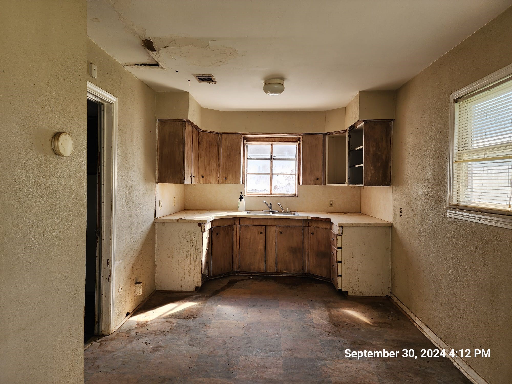 11645 Loop Road Beaumont, TX 77713 - Photo 6 of 20 a kitchen with cabinets and window