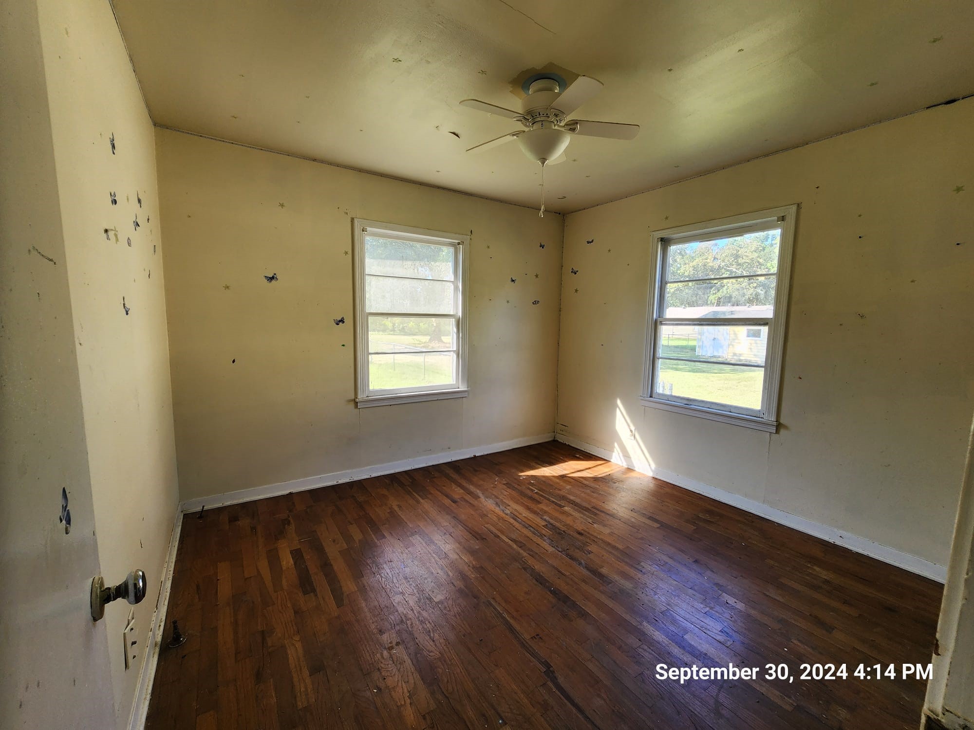 11645 Loop Road Beaumont, TX 77713 - Photo 9 of 20 a view of an empty room with a window and wooden floor