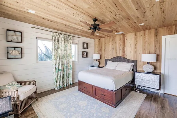 a spacious bedroom with a bed and a dresser