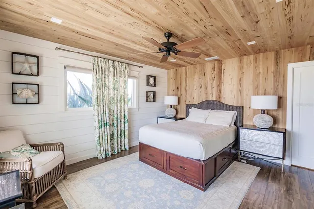 a spacious bedroom with a bed and a dresser