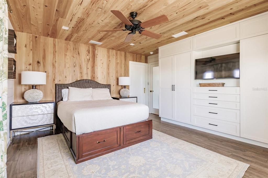 6020 Midnight Pass Road, Unit 26 Sarasota, FL 34242 - Photo 15 of 25 a spacious bedroom with a bed and a dresser