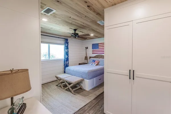 a bedroom with a bed and a chandelier