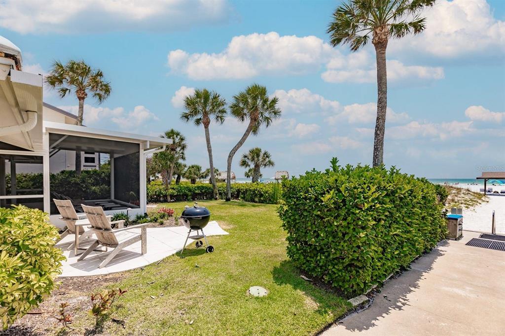 6020 Midnight Pass Road, Unit 26 Sarasota, FL 34242 - Photo 22 of 25 a view of a swimming pool with a bench and a fountain